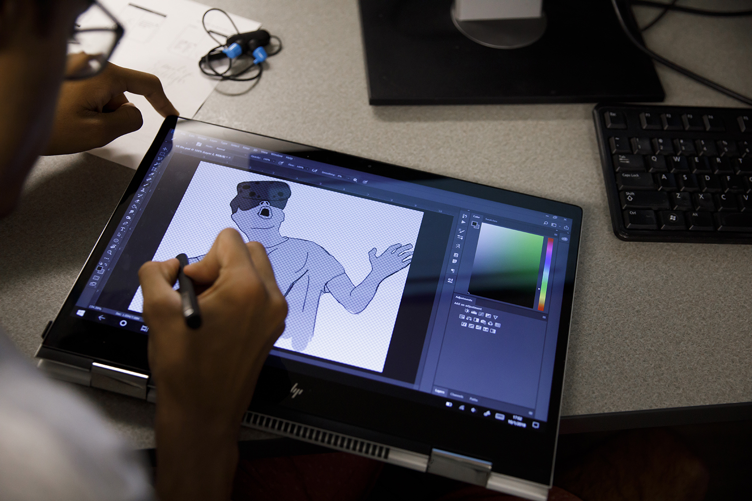 A student working on digital art on a tablet.